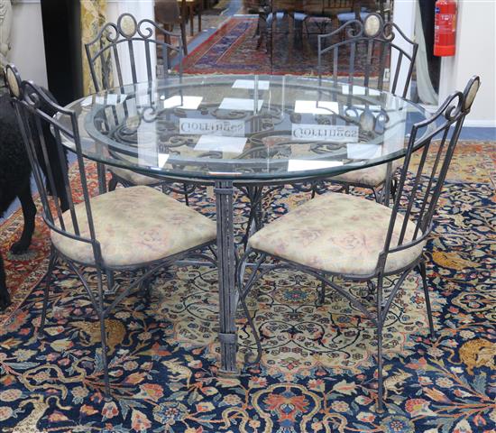 A French hand made wrought iron circular table with glass top and four chairs W.130cm